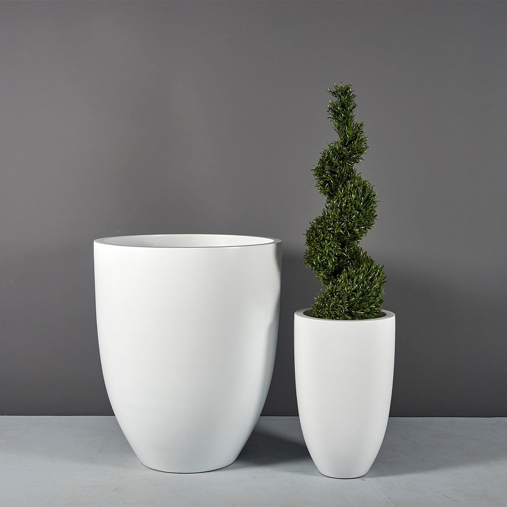 Brannan Tapered Round Fiberglass Planter shown with different sizes filled with plants.
