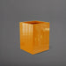 Brisane Tall Corner Fiberglass Planter in gloss tangerine against gray background.