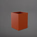 Brisane Tall Corner Fiberglass Planter in matte terra cotta against gray background.