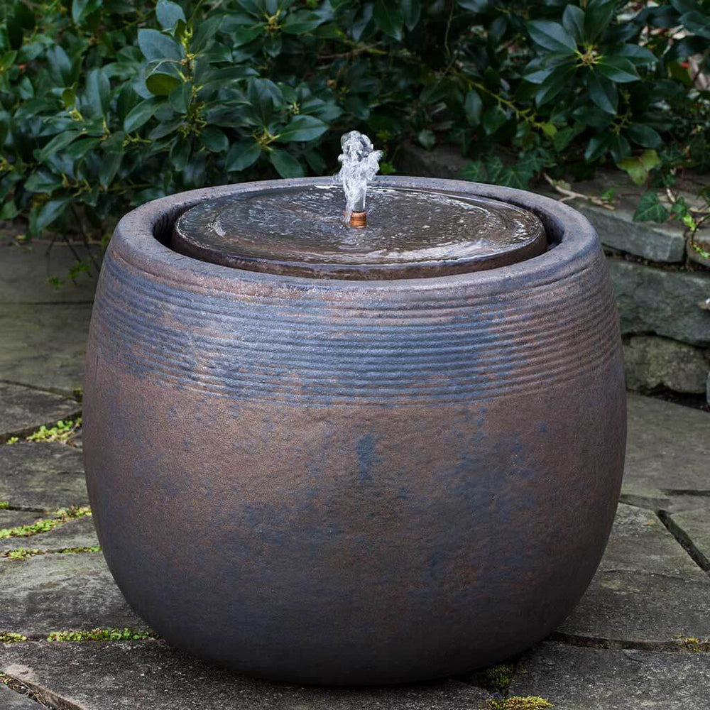 Bronze Boden Fountain Bubbler in action on stone patio