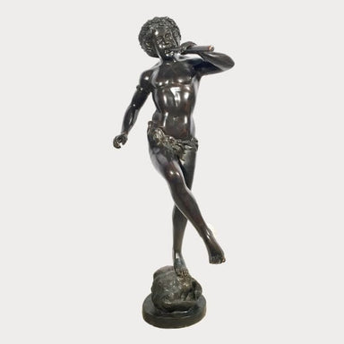 Bronze Boy playing flute fountain against gray background