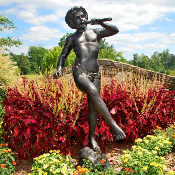 Bronze Boy playing flute fountain in the backyard