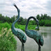 Bronze Crane Fountain Sculpture pair near lake