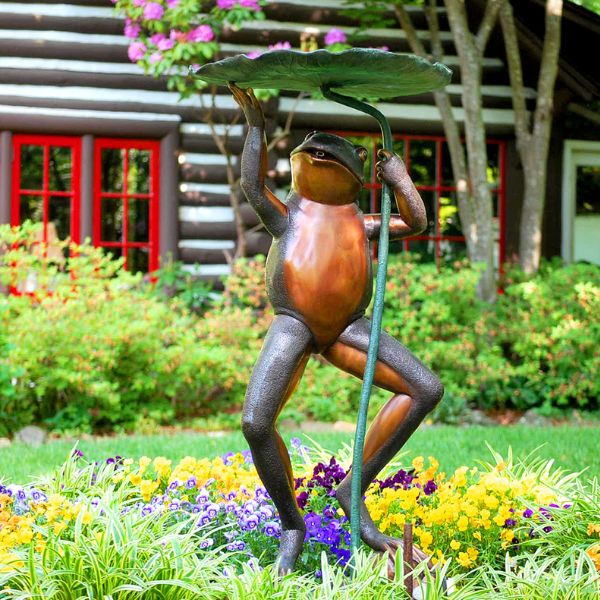 Bronze frog holding lily pad fountain in the backyard