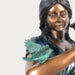 Bronze Girl with birdbath fountain sculpture  against gray background upclose