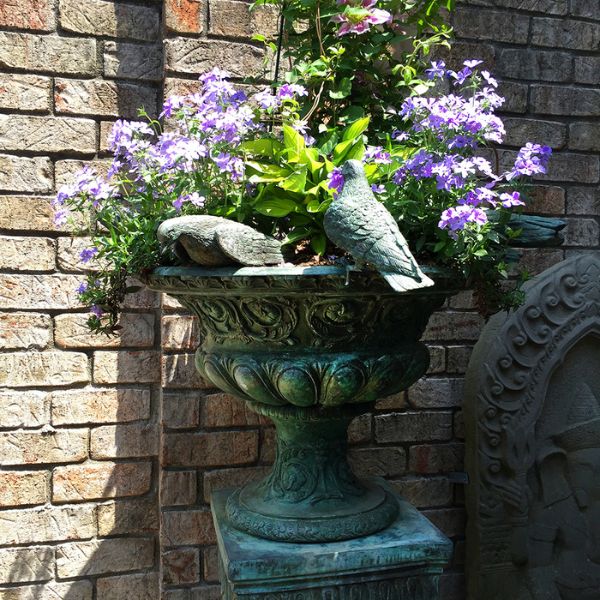 Bronze Seven Birds on vase fountain filled with purple flowers