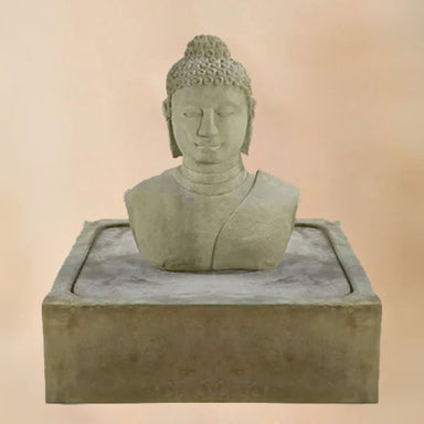 Buddha Bust Fountain against brown background.