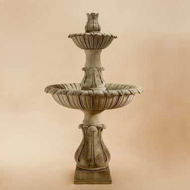 Calanthia Two Tier with Acanthus Finial against brown background.