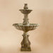 Calanthia Two Tier with Acanthus Finial against brown background.