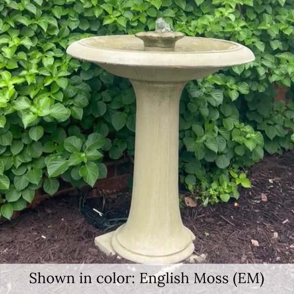 Camellia Birdbath Fountain running against green leaves