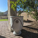 Campania Anduze Urn Planter filled with green plant on brick paver patio