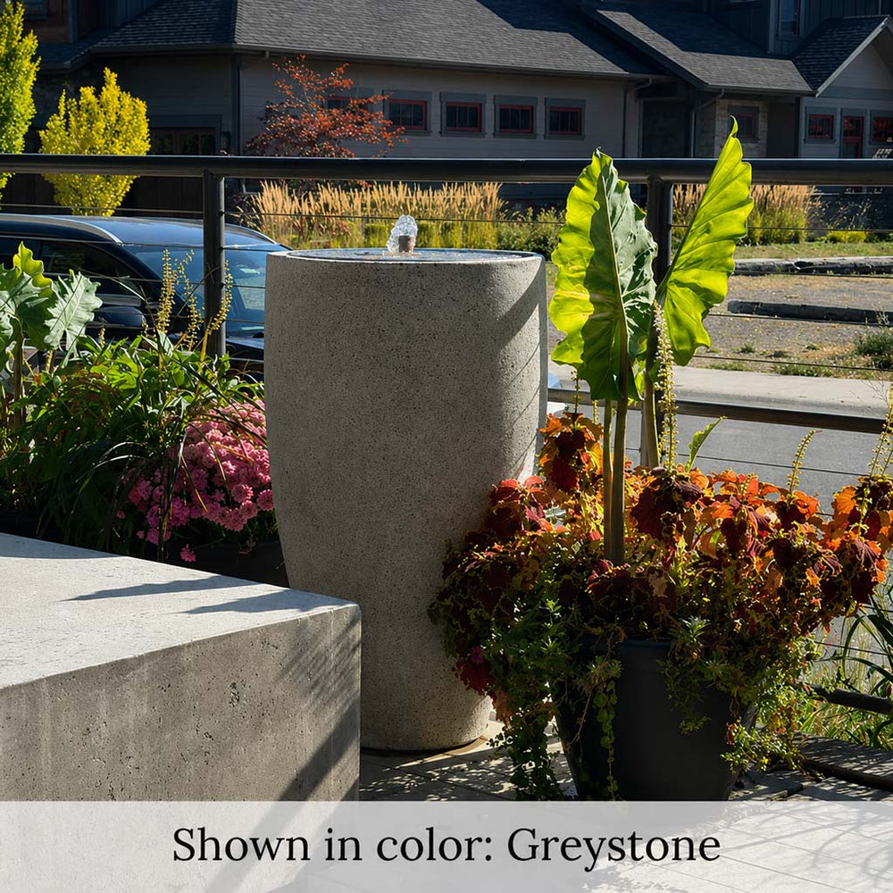 Campania Manzanita Fountain near plants on patio.