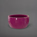 Casablanca Bowl Fiberglass Planter in gloss eggplant against gray background.