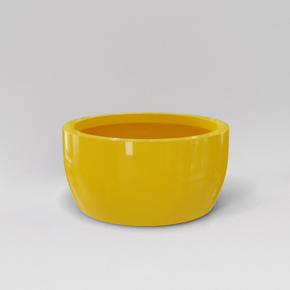 Casablanca Bowl Fiberglass Planter in gloss saffron against gray background.