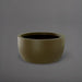 Casablanca Bowl Fiberglass Planter in matte bronze against gray background.