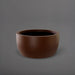 Casablanca Bowl Fiberglass Planter in matte dark brown against gray background.