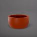 Casablanca Bowl Fiberglass Planter in matte terra cotta against gray background.