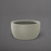 Casablanca Bowl Fiberglass Planter in satin beige against gray background.