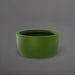 Casablanca Bowl Fiberglass Planter in satin green against gray background.
