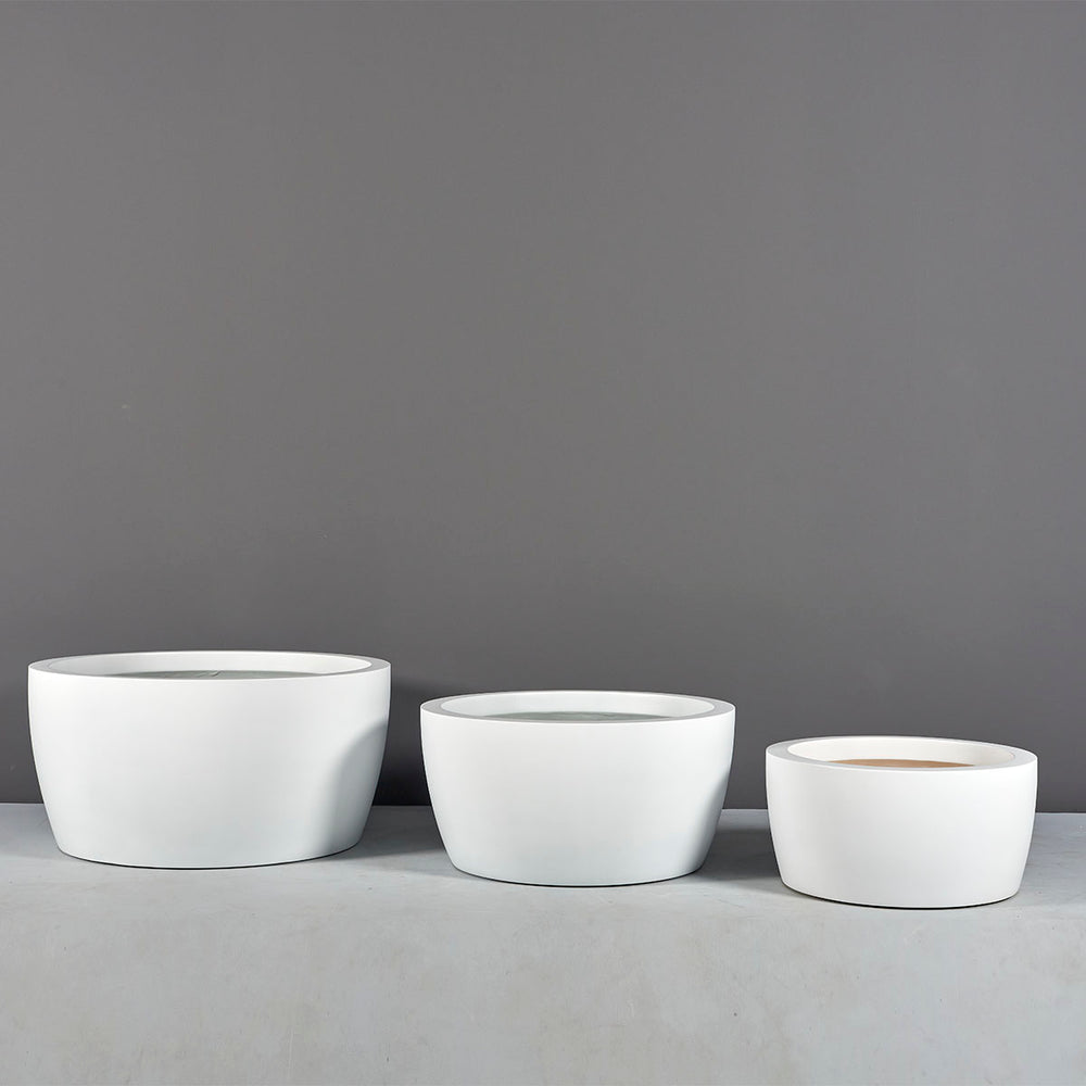 Casablanca Bowl Fiberglass Planter on concrete shown with different sizes.