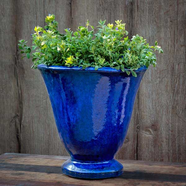 Caterine Urn - Riviera Blue - S/1 on table filled with plants