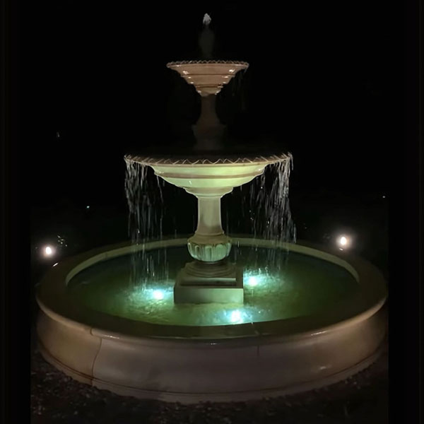 Charleston in Basin in french limestone in the backyard at night.