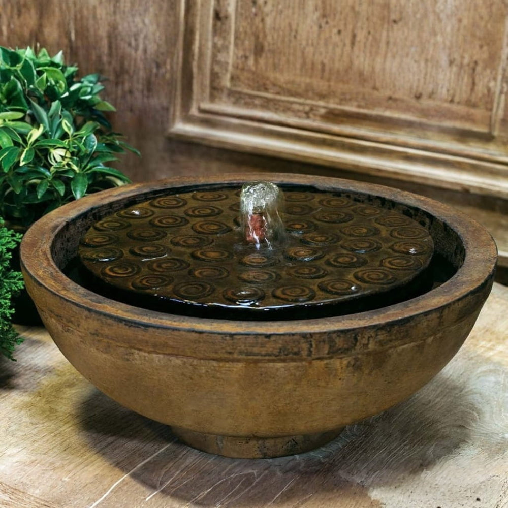 Cirrus Garden Terrace Fountain on concrete beside green plants