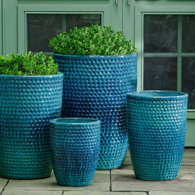 Coin Pot Planter, Tall - Aqua - S/4 on concrete filled with plants