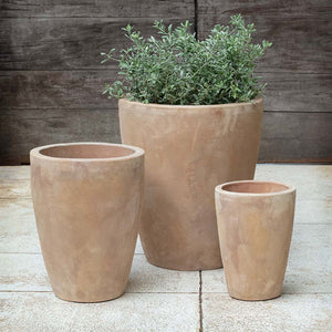Colburn Planter - Antico Terra Cotta - S/3 on concrete filled with plants