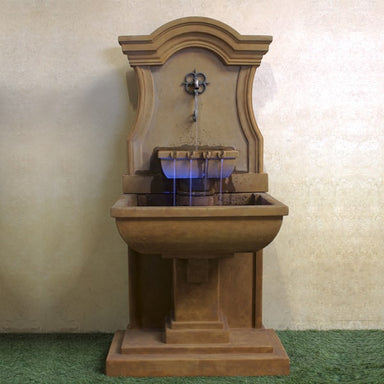 Colette Wall Fountain against brown background.