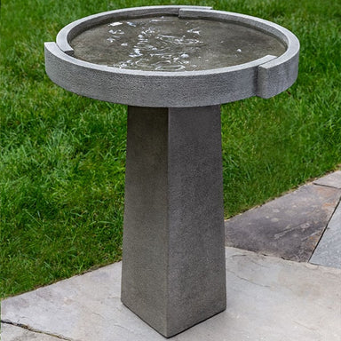 Concept Birdbath on concrete in the backyard