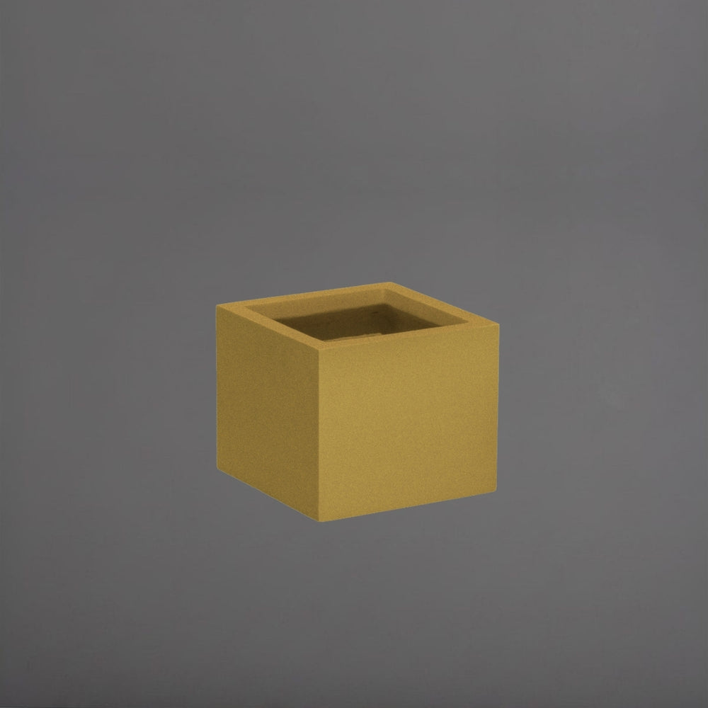 Cuba Low Corner Fiberglass Planter in gloss metallic gold against gray background.