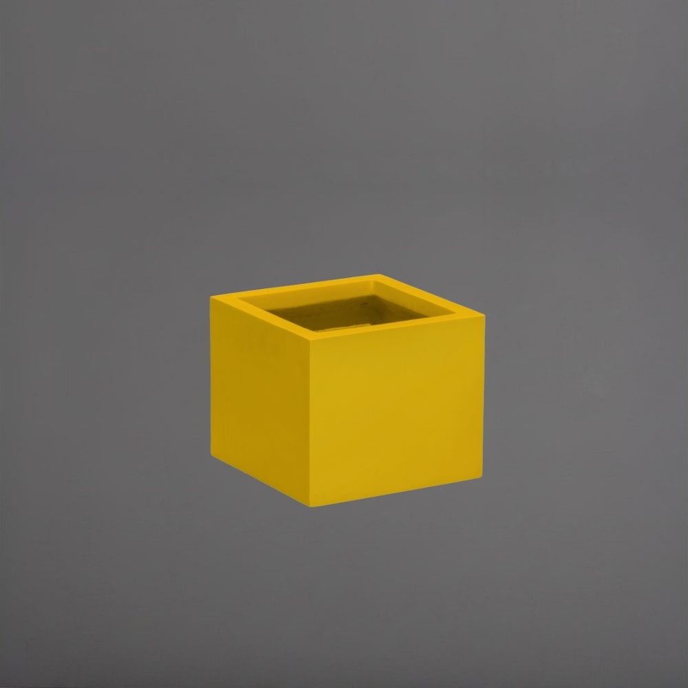 Cuba Low Corner Fiberglass Planter in gloss saffron against gray background.