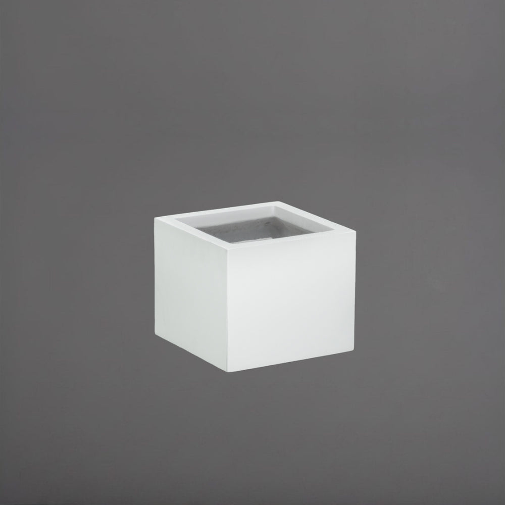 Cuba Low Corner Fiberglass Planter in matte bright white against gray background.
