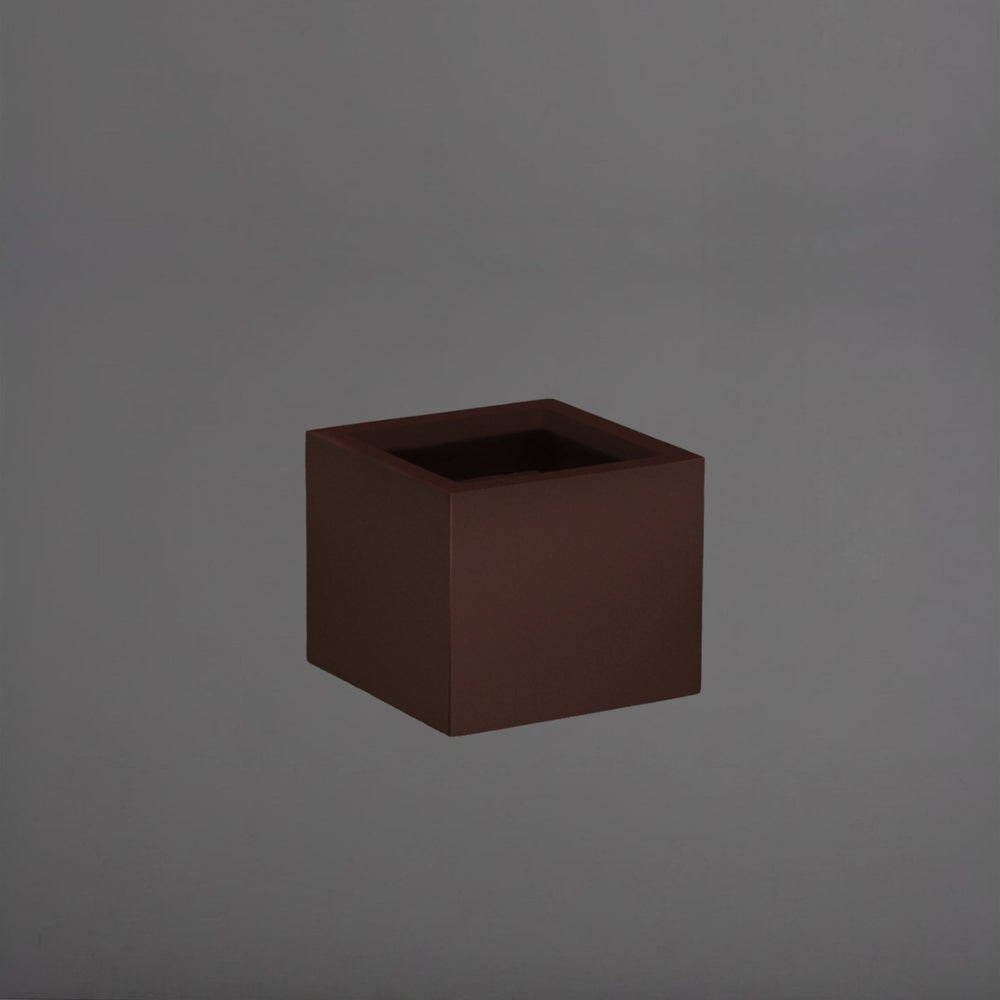 Cuba Low Corner Fiberglass Planter in matte dark brown against gray background.