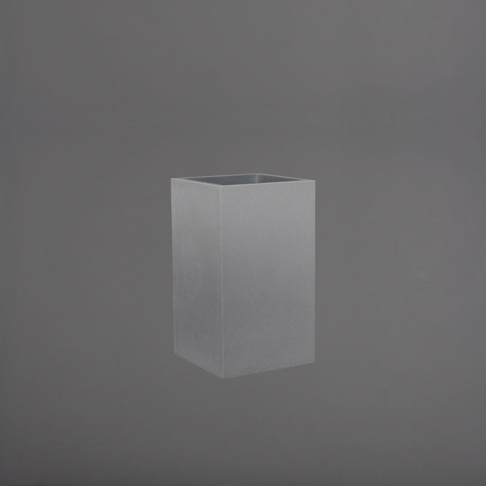 Cuba Low Corner Fiberglass Planter in matte gunmetal against gray background.