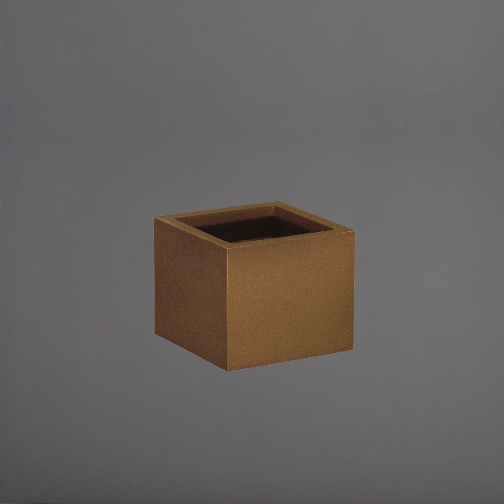Cuba Low Corner Fiberglass Planter in metallic bronze against gray background.