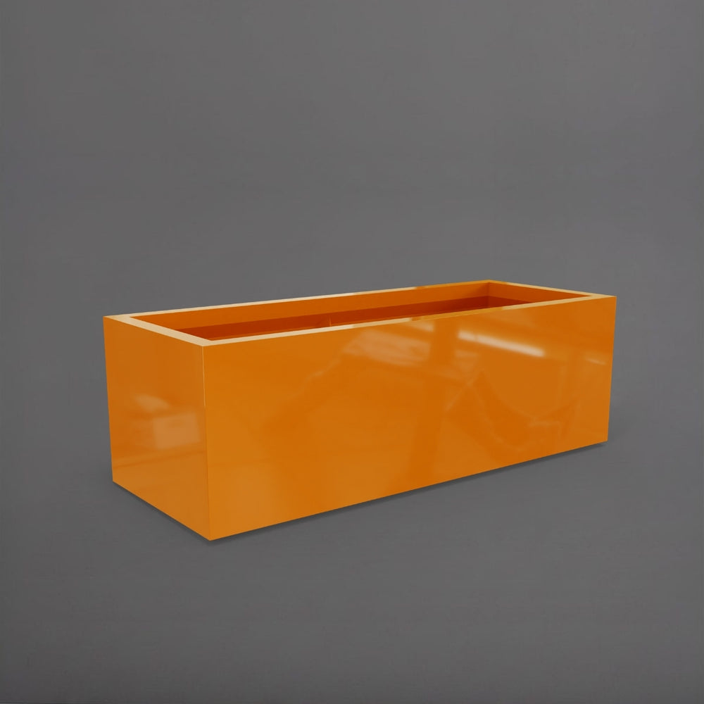Cuba Low Rectangle Fiberglass Planter in gloss tangerine against gray background.