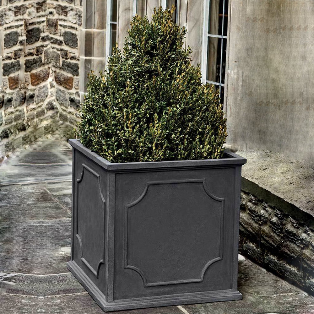 Cumberland Square Planter, Medium on concrete filled with plants.