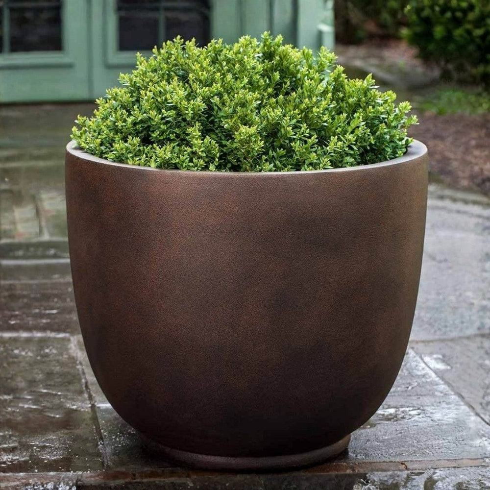 Danilo Planter Extra Large in rust lite on concrete in the backyard.