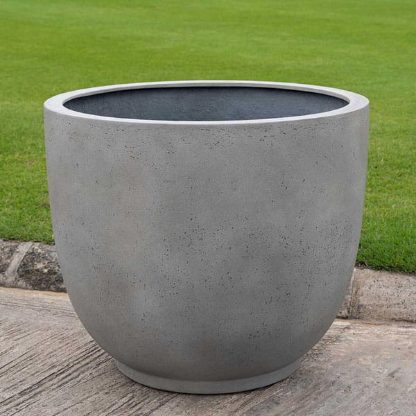Danilo Planter, Large in stone grey lite on concrete in the backyard.