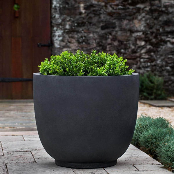 Danilo Planter, Medium in lead lite on concrete filled with plants.