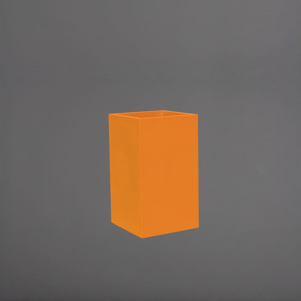 Darwin Tall Corner Fiberglass Planter in gloss tangerine against gray background.