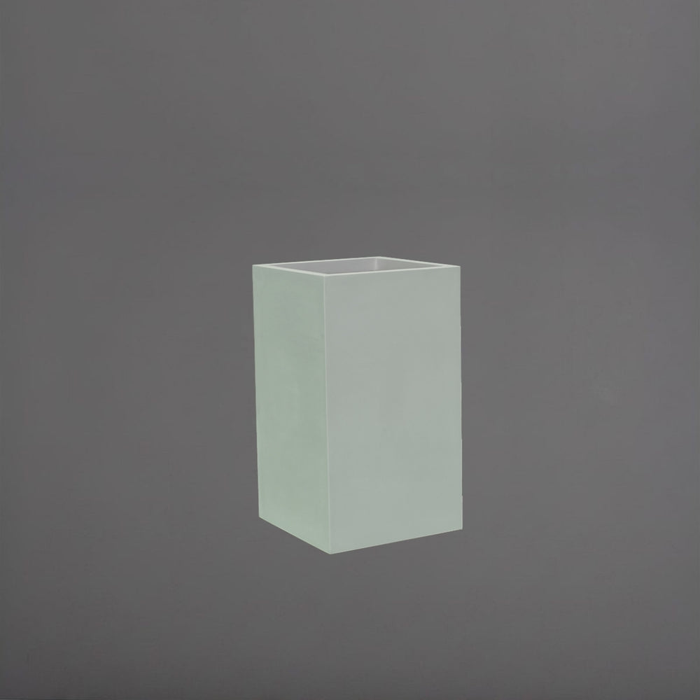 Darwin Tall Corner Fiberglass Planter in matte cement grey against gray background.