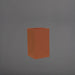 Darwin Tall Corner Fiberglass Planter in matte terra cotta against gray background.