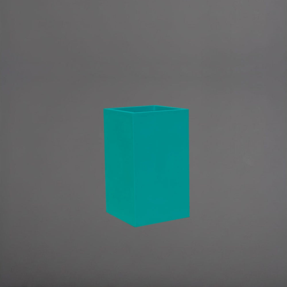 Darwin Tall Corner Fiberglass Planter in satin seafoam green against gray background.