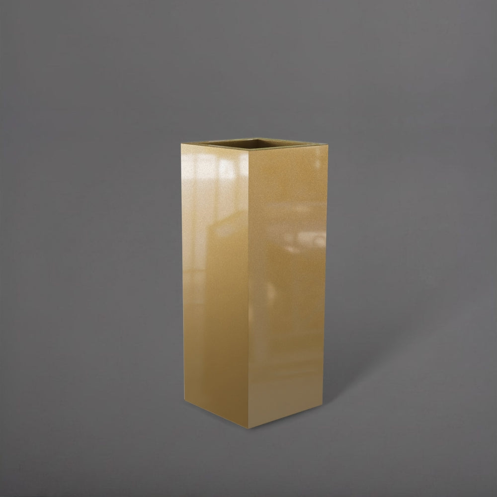 Delray Tall Corner Fiberglass Planter in gloss metallic gold against gray background.