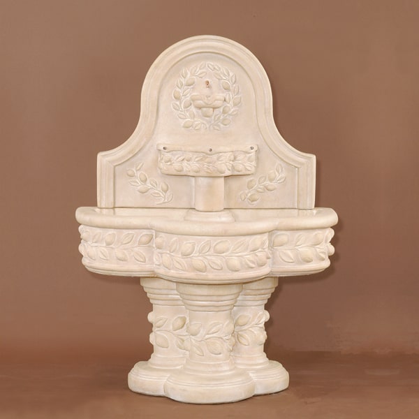 Deruta Lemon Wall Fountain against brown background.