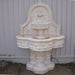 Deruta Lemon Wall Fountain in action against white fence.