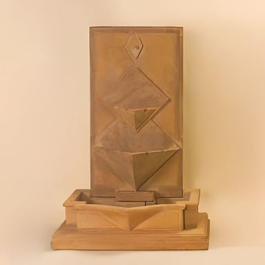 Diamante Wall Fountain against brown background.